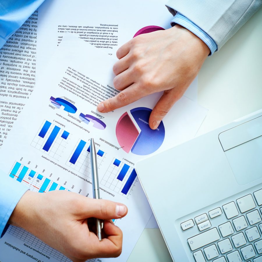 Close-up of female and male hands pointing at business document while discussing it